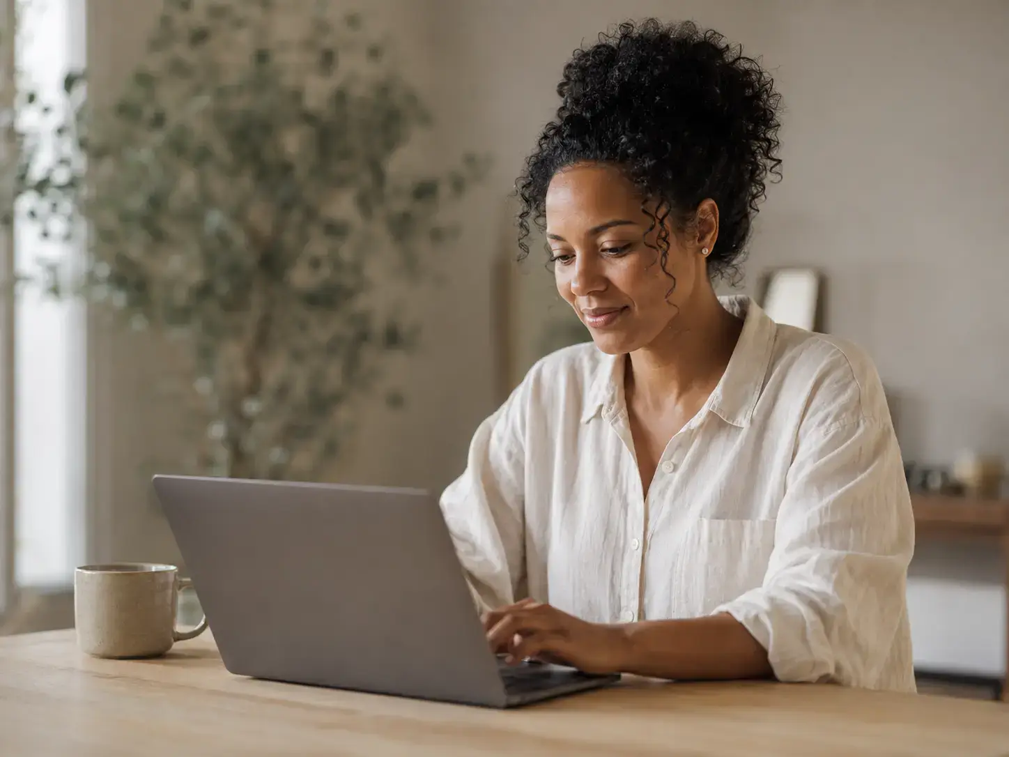 A happy patient writing a review of Star Aesthetic Centre on her laptop